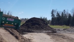 pile of compost beside trommel screen
