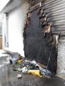 outside of a house is badly burned from fire