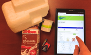 Styrofoam, milk carton, yogurt container and batteries beside a mobile device with someone accessing ovwrc.com